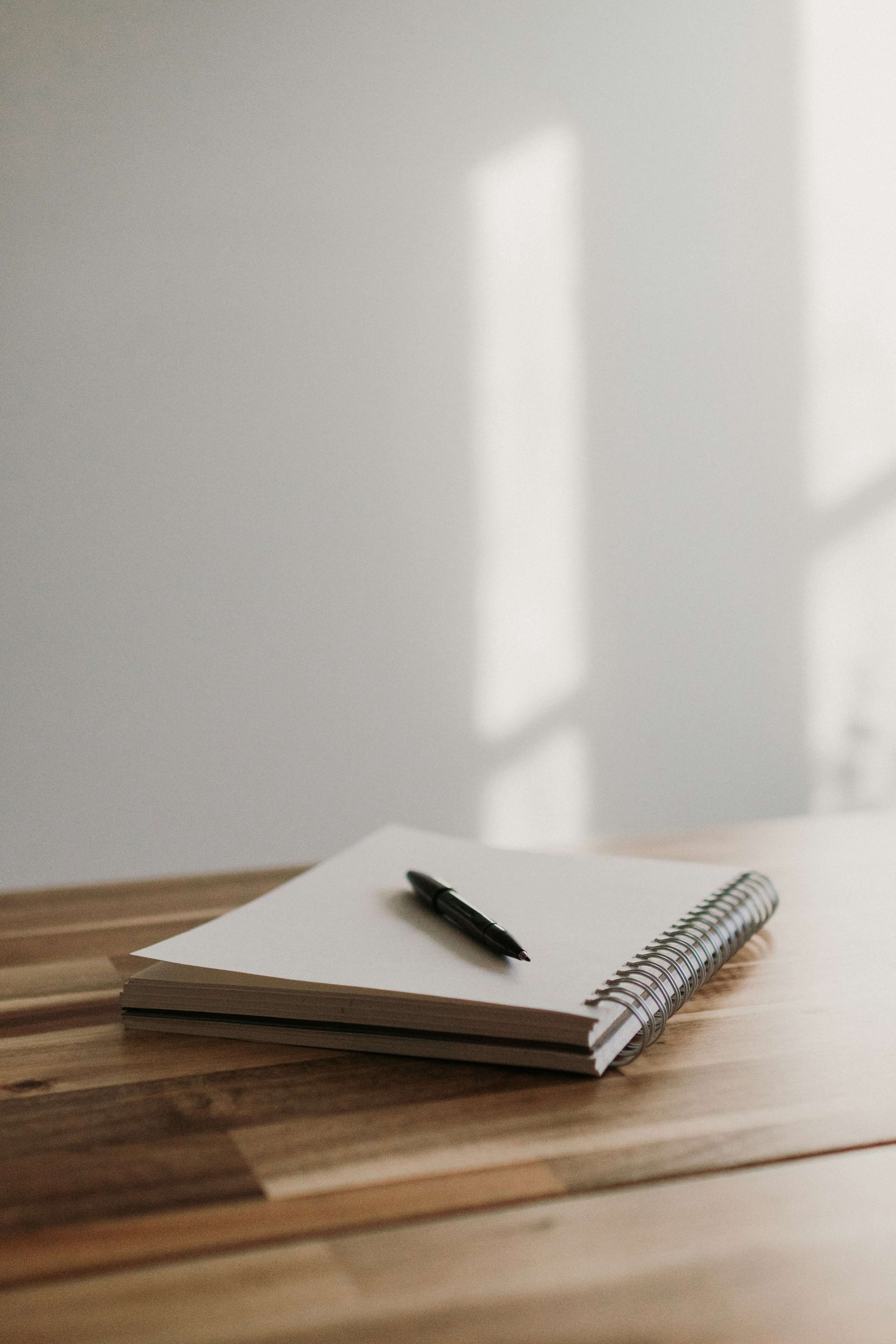 Open notebook and pen on a desk